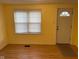 Bright living room featuring wood flooring, a neutral color scheme, and a large window by the entry door at 318 Tague St, Greenfield, IN 46140