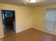 Inviting living room with laminate wood flooring, bright yellow walls, and natural light from a large window at 318 Tague St, Greenfield, IN 46140