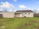 The house features a lush green lawn, with a storage shed in the backyard at 329 Roosevelt Dr, Shelbyville, IN 46176
