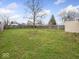 This backyard offers a large grassy area, with a fenced perimeter for added privacy at 329 Roosevelt Dr, Shelbyville, IN 46176