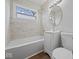 Bathroom with marble tile walls, sleek fixtures, and natural light at 329 Roosevelt Dr, Shelbyville, IN 46176