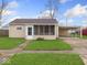 Charming single-story home featuring a well-maintained lawn and convenient covered parking at 329 Roosevelt Dr, Shelbyville, IN 46176