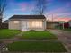 Charming single-story home featuring a well-maintained lawn and convenient covered parking at 329 Roosevelt Dr, Shelbyville, IN 46176