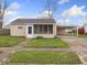 Charming single-story home featuring a well-maintained lawn and convenient covered parking at 329 Roosevelt Dr, Shelbyville, IN 46176
