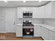 Modern kitchen featuring stainless steel appliances, marble countertops, and white cabinets at 329 Roosevelt Dr, Shelbyville, IN 46176