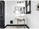 Bathroom with a vintage-inspired design, gold fixtures, white marble sink, and contrasting black trim at 425 E Walnut St, Indianapolis, IN 46202