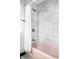 Bathtub with a unique patterned tile surround and shower featuring white fixtures for a clean, classic style at 425 E Walnut St, Indianapolis, IN 46202