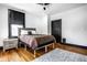 Inviting bedroom features a light-filled space with neutral decor, hardwood flooring, and ceiling fan at 425 E Walnut St, Indianapolis, IN 46202