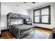 Bedroom with a bunk bed, natural light, hardwood floors, and neutral colors creating a versatile space at 425 E Walnut St, Indianapolis, IN 46202