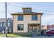 Charming two-story home featuring a dormer window and light yellow siding and green trim accents at 425 E Walnut St, Indianapolis, IN 46202