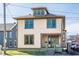 Charming two-story home featuring a dormer window and light yellow siding and green trim accents at 425 E Walnut St, Indianapolis, IN 46202