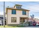 Charming two-story home featuring a dormer window and light yellow siding with green trim accents at 425 E Walnut St, Indianapolis, IN 46202
