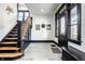 Inviting foyer with hardwood floors, black trim, white walls, and a staircase on the left at 425 E Walnut St, Indianapolis, IN 46202