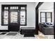 Inviting foyer featuring black trim, hardwood floors, white walls, and decorative accents at 425 E Walnut St, Indianapolis, IN 46202
