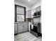 Modern kitchen with stainless steel appliances, gray cabinets, and ample counter space at 425 E Walnut St, Indianapolis, IN 46202