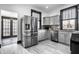 Updated kitchen with stainless steel appliances, gray cabinets, and modern finishes at 425 E Walnut St, Indianapolis, IN 46202
