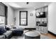 Bright living room with modern furniture, a fireplace, hardwood floors, and large windows at 425 E Walnut St, Indianapolis, IN 46202