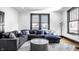 Bright living room featuring modern furniture, hardwood floors, and large windows with light at 425 E Walnut St, Indianapolis, IN 46202