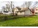The backyard features a well-maintained lawn, a wooden fence, and a small deck at 4610 W 72Nd St, Indianapolis, IN 46268