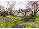 The home has a green backyard with a recently tilled garden and some mature trees at 4610 W 72Nd St, Indianapolis, IN 46268