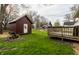 Backyard featuring a shed, a deck, and a small fire pit area at 4610 W 72Nd St, Indianapolis, IN 46268
