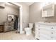 Bathroom featuring a toilet, walk-in closet and white vanity with quartz countertop at 4610 W 72Nd St, Indianapolis, IN 46268