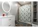 Bright bathroom featuring a white vanity and a bathtub with a whimsical shower curtain at 4610 W 72Nd St, Indianapolis, IN 46268