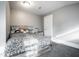Bright bedroom features a bed with stylish headboard, neutral walls and plush carpeting at 4610 W 72Nd St, Indianapolis, IN 46268
