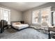 Comfortable bedroom has natural light, a bed, a desk, and cozy carpeting at 4610 W 72Nd St, Indianapolis, IN 46268