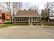 Classic home featuring a brick sunroom, complemented by a well-kept front yard at 4610 W 72Nd St, Indianapolis, IN 46268