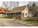 Charming home featuring brick and siding, with a sunroom and well-maintained landscaping at 4610 W 72Nd St, Indianapolis, IN 46268