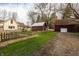 This house has a fenced yard, grassy area, and exterior buildings with mature trees surrounding the property at 4610 W 72Nd St, Indianapolis, IN 46268