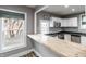 Modern kitchen featuring white cabinets, stainless steel appliances, and a breakfast bar, filled with natural light at 4610 W 72Nd St, Indianapolis, IN 46268