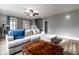 Spacious living room with wood floors features a large sectional sofa, windows, and natural light at 4610 W 72Nd St, Indianapolis, IN 46268