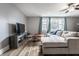 Inviting living room boasts a comfortable sectional sofa, a media center and great natural light at 4610 W 72Nd St, Indianapolis, IN 46268