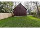 This shows a barn with aged wood and a slatted window at the peak, next to a wood fence at 4610 W 72Nd St, Indianapolis, IN 46268