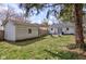 Lush backyard featuring patio seating, a fire pit, a storage shed, and a well-maintained lawn at 5937 Guilford Ave, Indianapolis, IN 46220