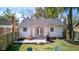 Landscaped backyard with a seating area, grill, manicured lawn, fenced yard and French doors at 5937 Guilford Ave, Indianapolis, IN 46220