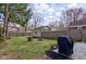 Expansive backyard featuring green grass, a small storage shed, wooden fence, and outdoor seating at 5937 Guilford Ave, Indianapolis, IN 46220