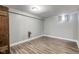 View of the basement featuring light gray walls and wood-look flooring at 5937 Guilford Ave, Indianapolis, IN 46220