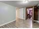 Basement featuring wood-look floors, light gray walls, and access to storage at 5937 Guilford Ave, Indianapolis, IN 46220