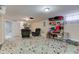 Finished basement with a mosaic tile floor, two reclining chairs, and ample storage shelves at 5937 Guilford Ave, Indianapolis, IN 46220