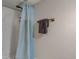 Bathroom showcasing a bathtub with a blue shower curtain and a towel rack at 5937 Guilford Ave, Indianapolis, IN 46220
