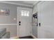 Bright entryway featuring a white door with glass panes, neutral walls, and classic trim detailing at 5937 Guilford Ave, Indianapolis, IN 46220