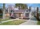 Charming home showcasing a well-manicured front lawn, inviting porch, and classic architectural details at 5937 Guilford Ave, Indianapolis, IN 46220