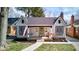 Charming home featuring a covered front porch with swing, well-kept lawn, and mature landscaping at 5937 Guilford Ave, Indianapolis, IN 46220