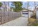 Detached garage with gravel driveway and a wooden fence at 5937 Guilford Ave, Indianapolis, IN 46220