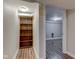 Hallway with hardwood floors and a built-in bookshelf leading to another room with plank flooring at 5937 Guilford Ave, Indianapolis, IN 46220