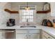 Bright kitchen with stainless steel sink, quartz countertops, and subway tile backsplash at 5937 Guilford Ave, Indianapolis, IN 46220