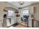 Well-lit kitchen with white cabinets, quartz counters, and stainless steel appliances at 5937 Guilford Ave, Indianapolis, IN 46220